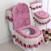 A pink antibacterial toilet seat cover set featuring a quilted cushion and decorative lace trim.