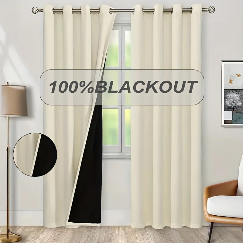 A pair of cream blackout curtains hanging in a window frame.