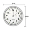 A white mini quartz clock face showing the time, with a 4cm diameter and luminous hands.