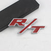 A silver and red metal emblem featuring the SRT logo on a black surface.