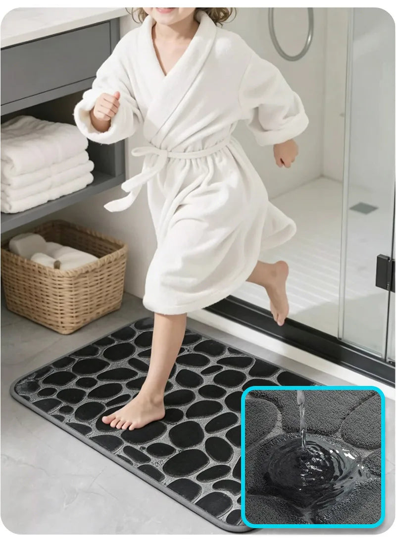A child wearing a white plush non-slip absorbent bathroom rug with pebble texture on a black mat.