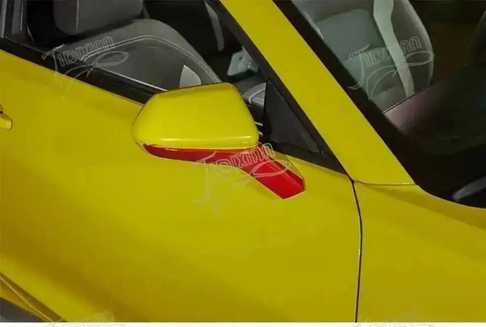 Yellow exterior trim and red interior trim kit for a Chevrolet Camaro car door panel.