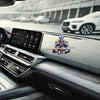 A hand-painted Monkey King figurine with a staff displayed on a car's interior dashboard.