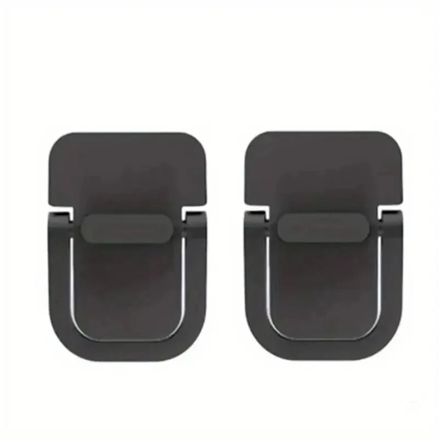 A pair of black minimal aluminum laptop risers with adhesive mounting pads.