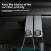 A close-up of a car seat back hook with a suede finish hanging from the interior of a car, designed for organizing bags and a