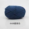 A ball of dark blue 4-ply milk cotton yarn for knitting and crochet.