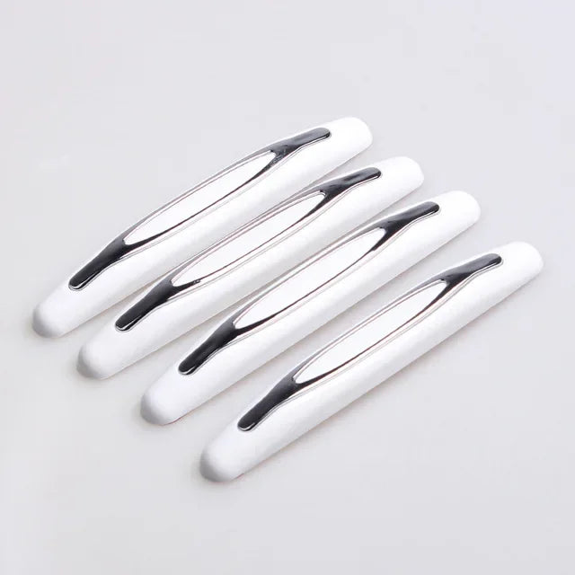 A pack of four white car door edge protector strips shown diagonally on a light gray background.