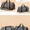 A black and white leopard print travel tote bag with handles and a shoe compartment.