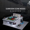 A detailed 1:64 scale model of a sunroom scene featuring cars and landscaping.