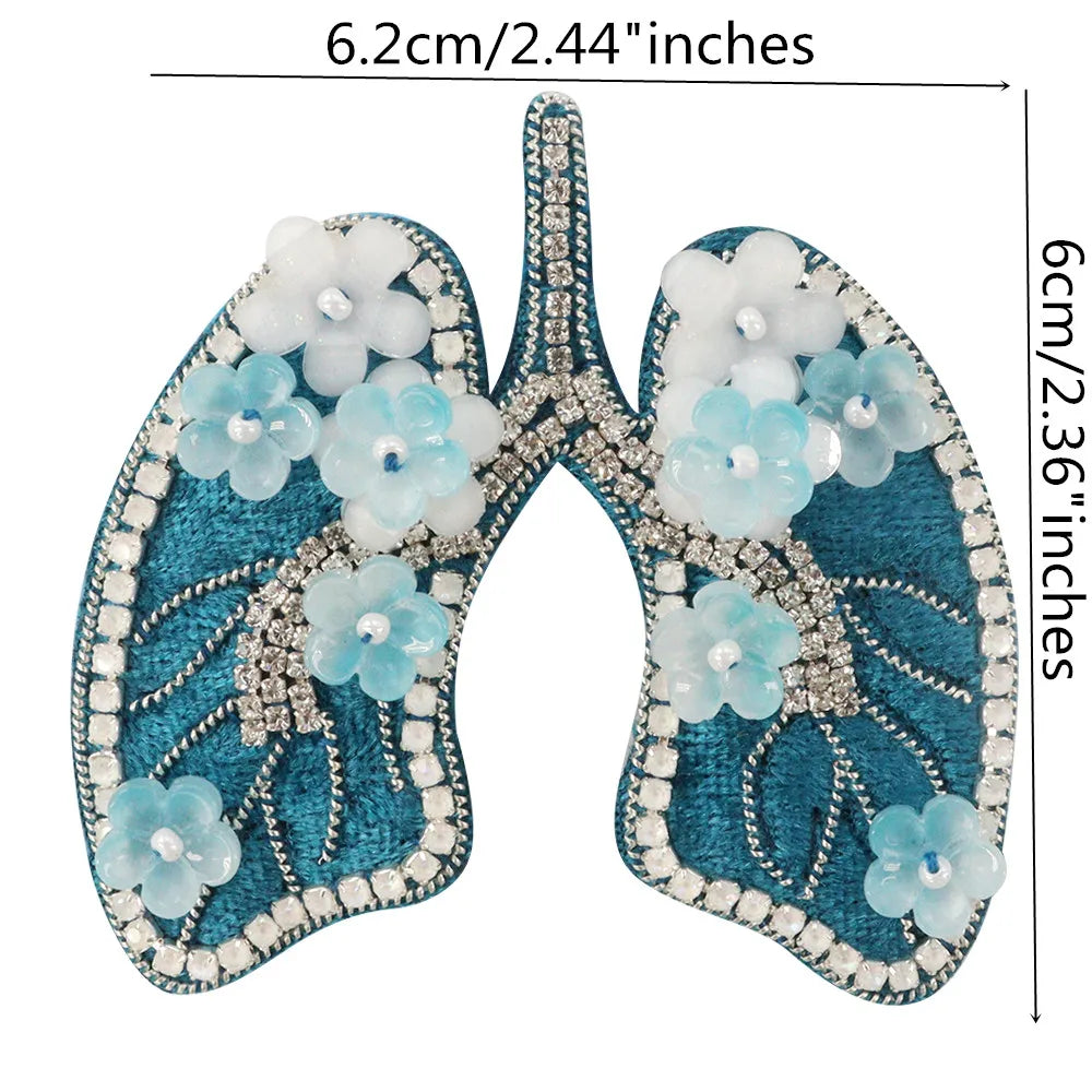 A pair of sparkling beaded rhinestone patches shaped like wings in teal and white flowers for clothing and crafts.