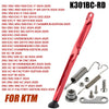 Red KTM side stand kit with ABS foot and various motorcycle parts