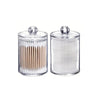 Clear acrylic jar with a lid holding numerous cotton balls or swabs.
