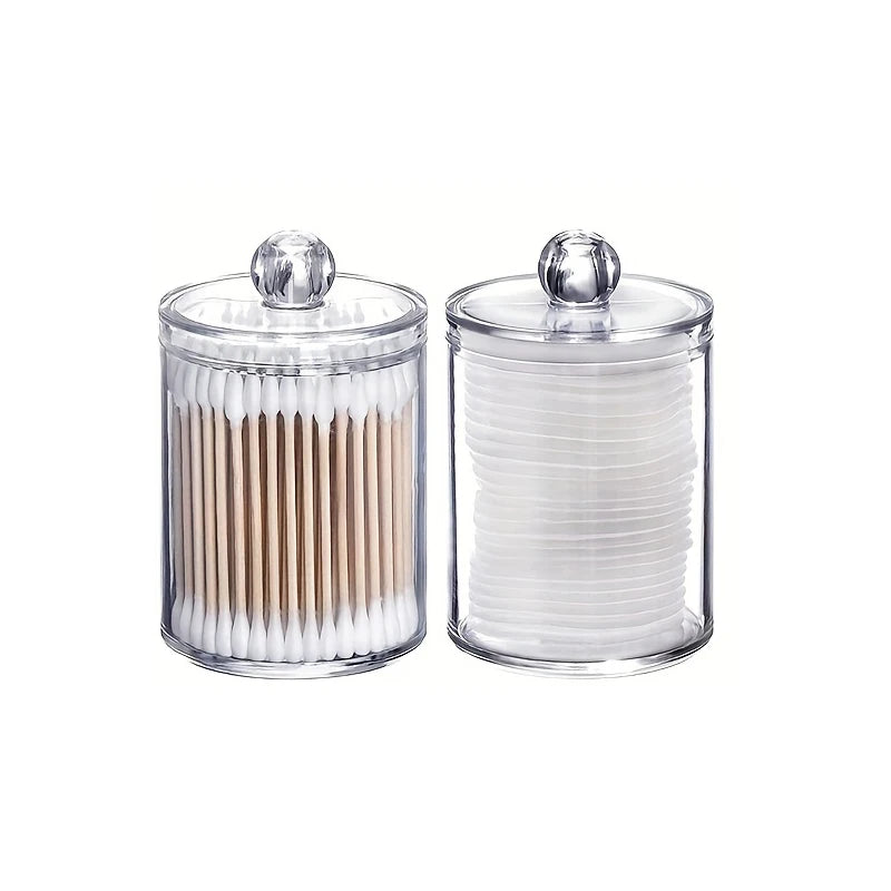 Clear acrylic jar with a lid holding numerous cotton balls or swabs.