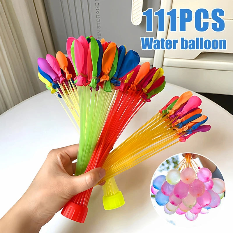 A hand holds a bunch of colorful water balloons with various colors like pink, orange, blue, and green.