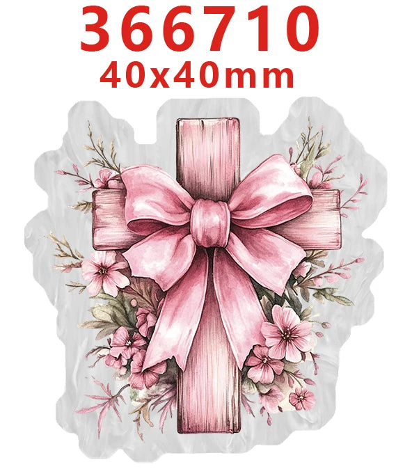 A pink acrylic hair bow decoration shaped like a cross with floral accents.