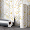 Rolls of silver and white marble peel-and-stick wall panels displayed against a marbled background.