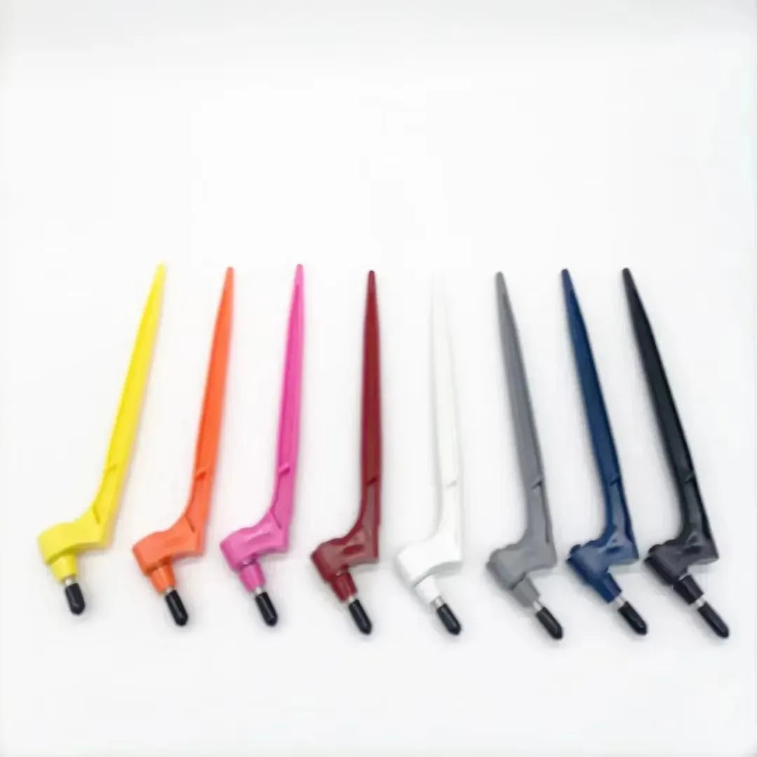 A row of seven precision craft knife blades in various colors including yellow, orange, pink, red, white, gray, and blue.