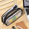A clear mesh pencil case with black trim is shown open, containing various school and office supplies on a wooden surface.