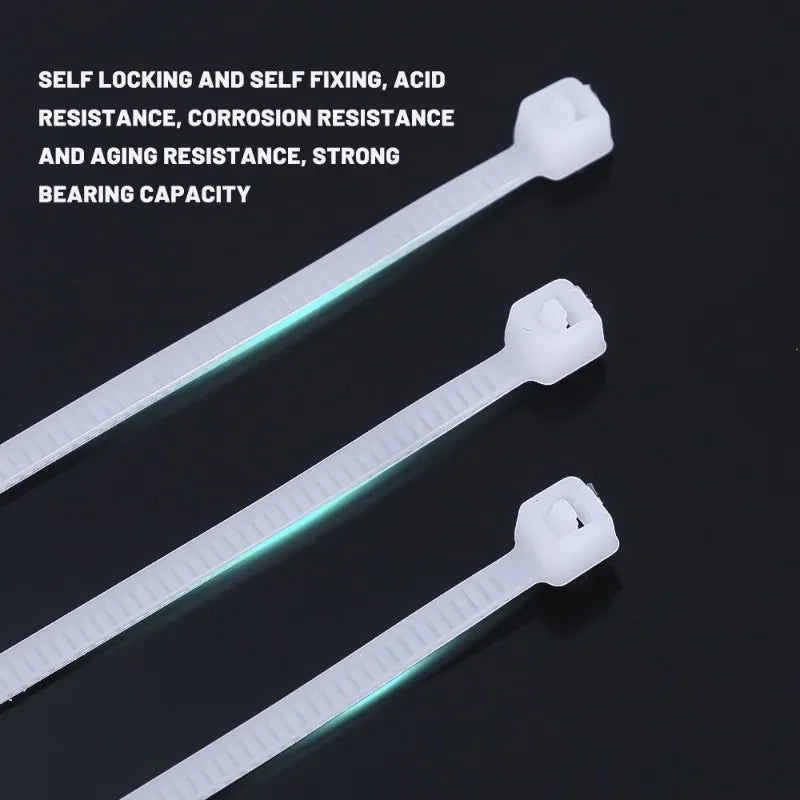 Three white nylon self-locking cable ties are shown against a dark background.