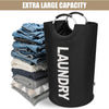 A black collapsible laundry basket with a handle is shown next to folded blue and gray clothes.
