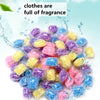 A pile of colorful water-soluble laundry fragrance beads in various shades of purple, blue, and yellow.