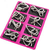 A pink plastic tray holding various silver metal wire puzzle brain teaser components.