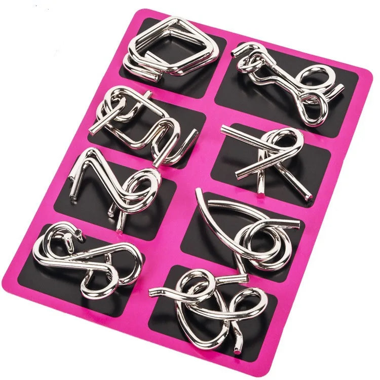 A pink plastic tray holding various silver metal wire puzzle brain teaser components.