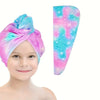 A pink and blue microfiber hair drying towel wrap is shown next to a smiling child's face.