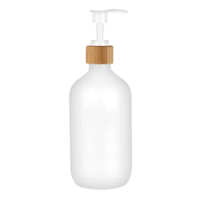 A white refillable soap dispenser bottle with a wooden pump top.