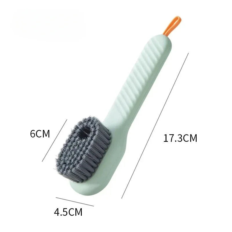 A light green shoe washing machine bag with a white handle and a grey soft bristled cleaning brush set.
