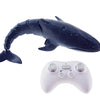 A dark blue shark toy with a fin and a white remote control gamepad.