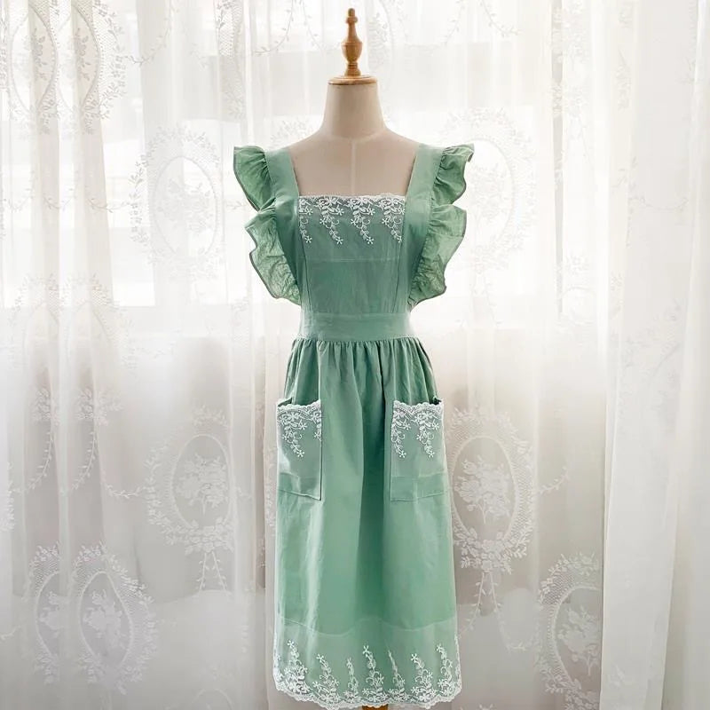 Mint green ruffled cotton linen kitchen apron with lace trim displayed on a mannequin.