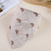 A light beige cotton baby bib with a repeating brown rainbow pattern, shown from above.