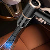 A handheld vacuum cleaner is shown cleaning a car seat fabric with blue suction power.