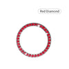 A circular crystal rhinestone start/stop button cover, set with red diamonds.