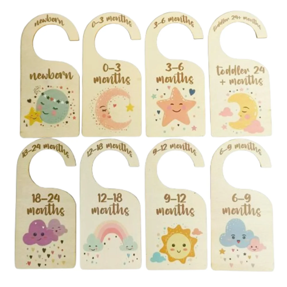 A set of wooden baby closet dividers with cartoon labels for newborn to six-nine months.