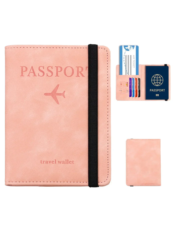A pink leather passport wallet with a black strap and an accompanying card holder.