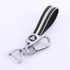 Black and silver TPU leather car key cover with a metal keychain attached.