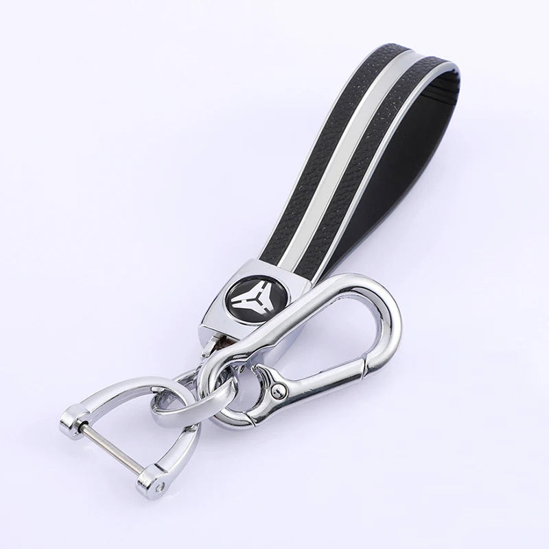 Black and silver TPU leather car key cover with a metal keychain attached.