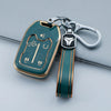 A teal TPU smart key fob cover with a silver chain and black fob attached, resting on a gray surface.