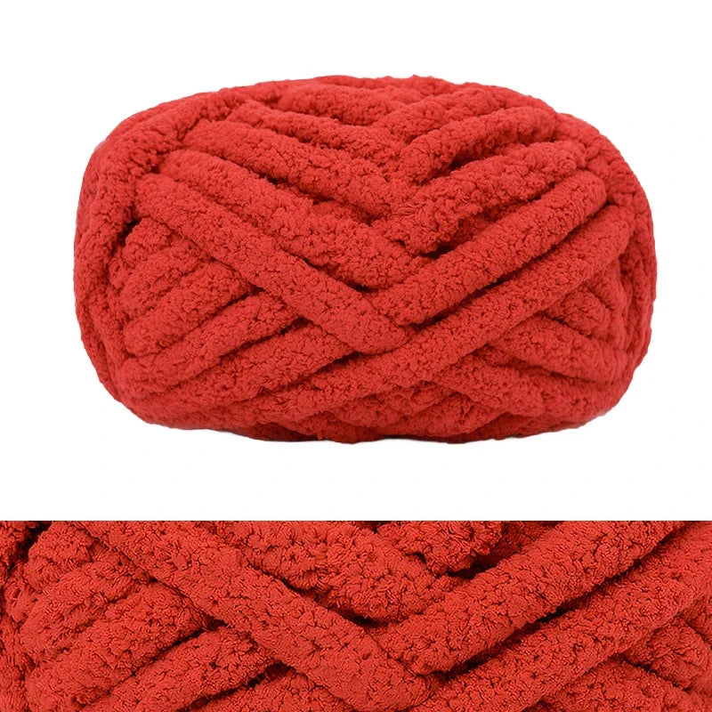 A ball of chunky red chenille yarn used for hand knitting and crochet