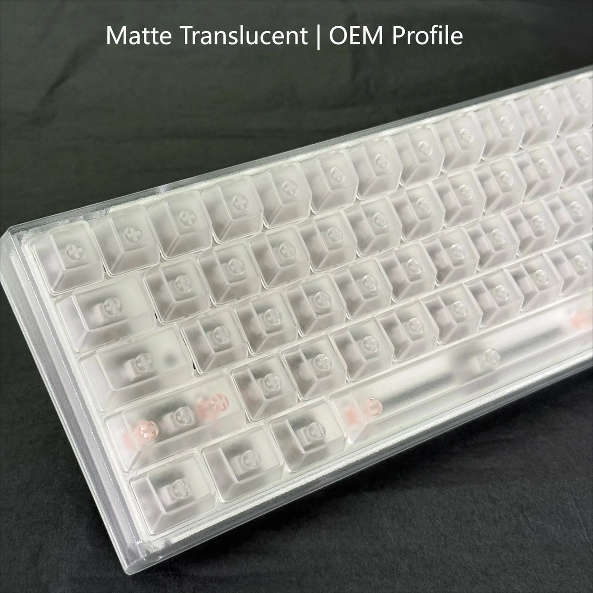 A clear plastic profile of translucent keycaps for mechanical keyboards, showing various keycap shapes.