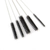 A set of carburetor cleaning needles and brushes with long metal wires displayed on a white background.