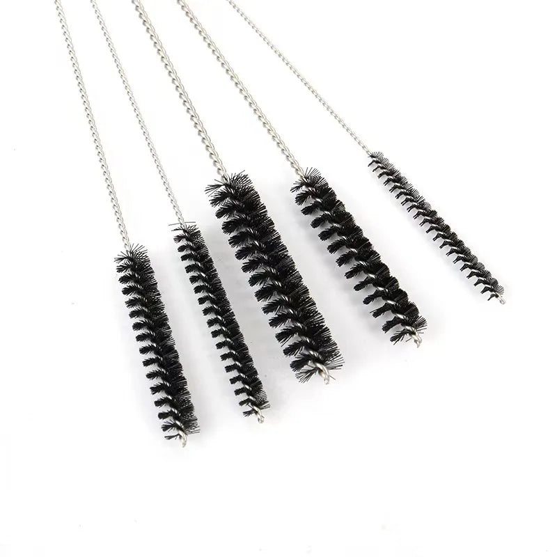 A set of carburetor cleaning needles and brushes with long metal wires displayed on a white background.