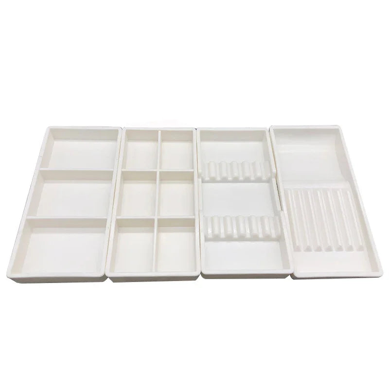 White plastic drawer organizer tray with multiple compartments for dental instruments