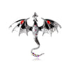 A detailed enamel dragon brooch featuring black and white scales with colorful rhinestone accents.