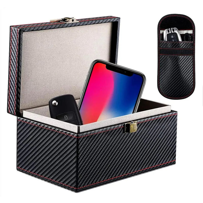 A black carbon fiber box with a lid open, containing a smartphone and a key fob.