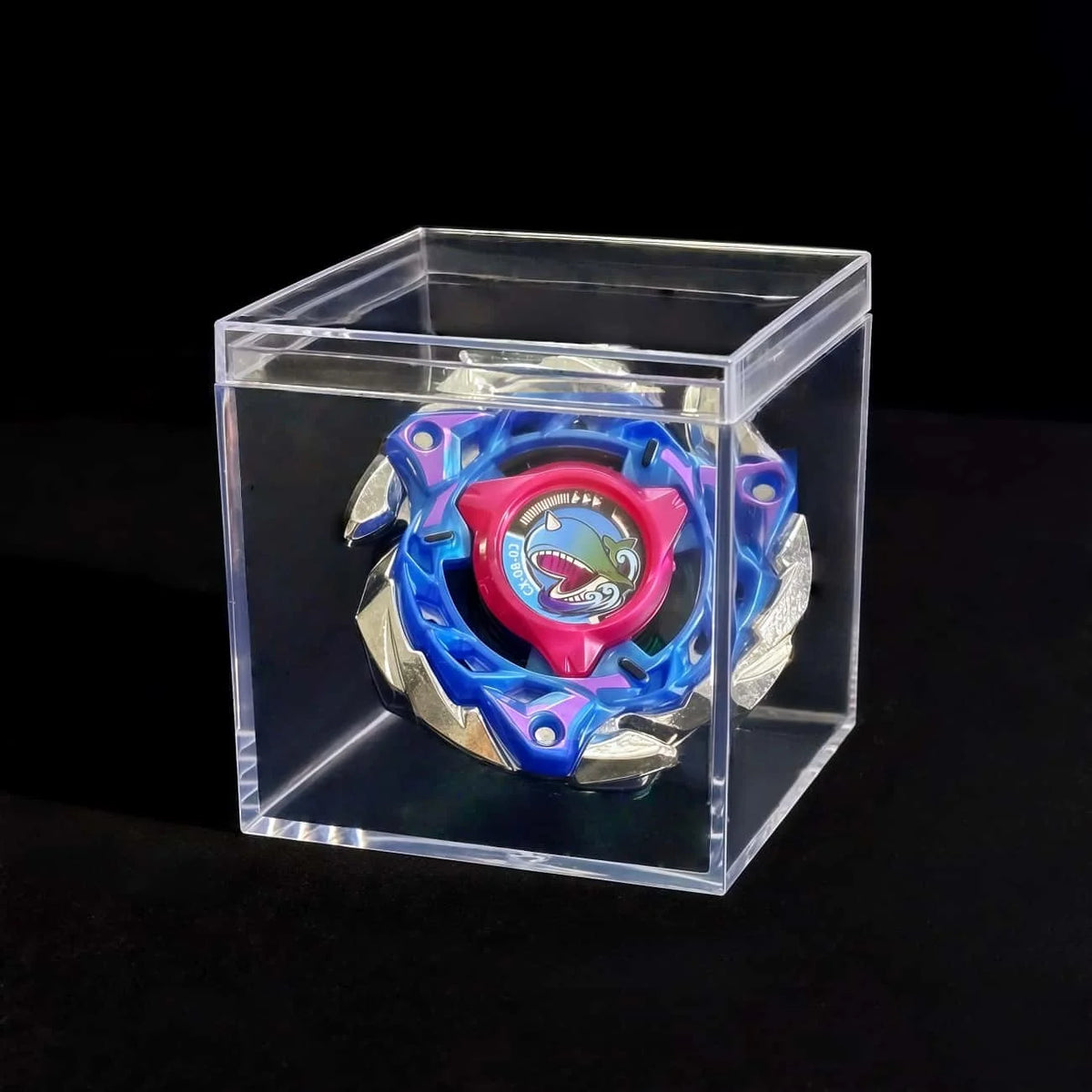 A Valkyrie Volt S4-70V metal spinning top with launcher displayed inside a clear plastic box.