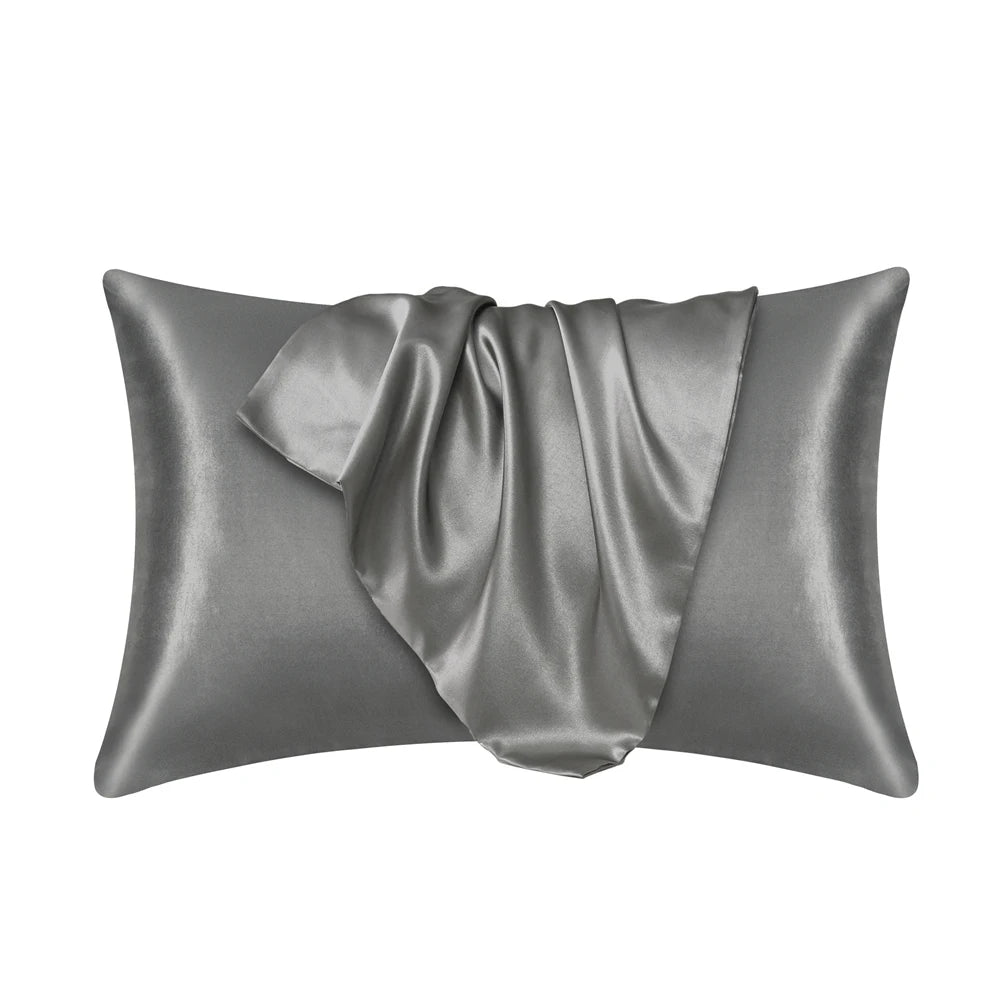 A smooth, gray satin pillowcase draped on a surface.