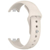 A white silicone replacement strap for a fitness tracker, shown from the side.